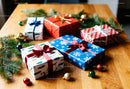 Holiday gifts wrapped in festive paper on wooden table