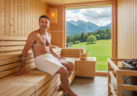 Man Relaxing in Wooden Sauna Room with Mountain View