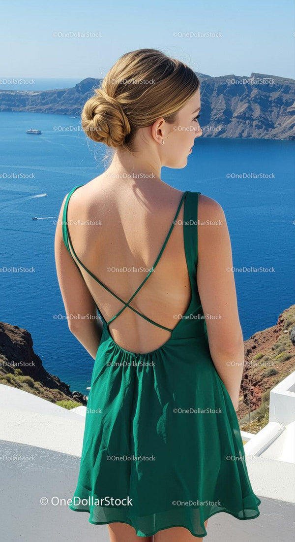 Woman in green dress enjoying stunning seaside view