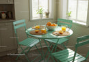 Sunny kitchen table set with fresh orange juice and fruit