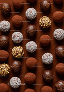 Assorted gourmet chocolate truffles on cocoa powder