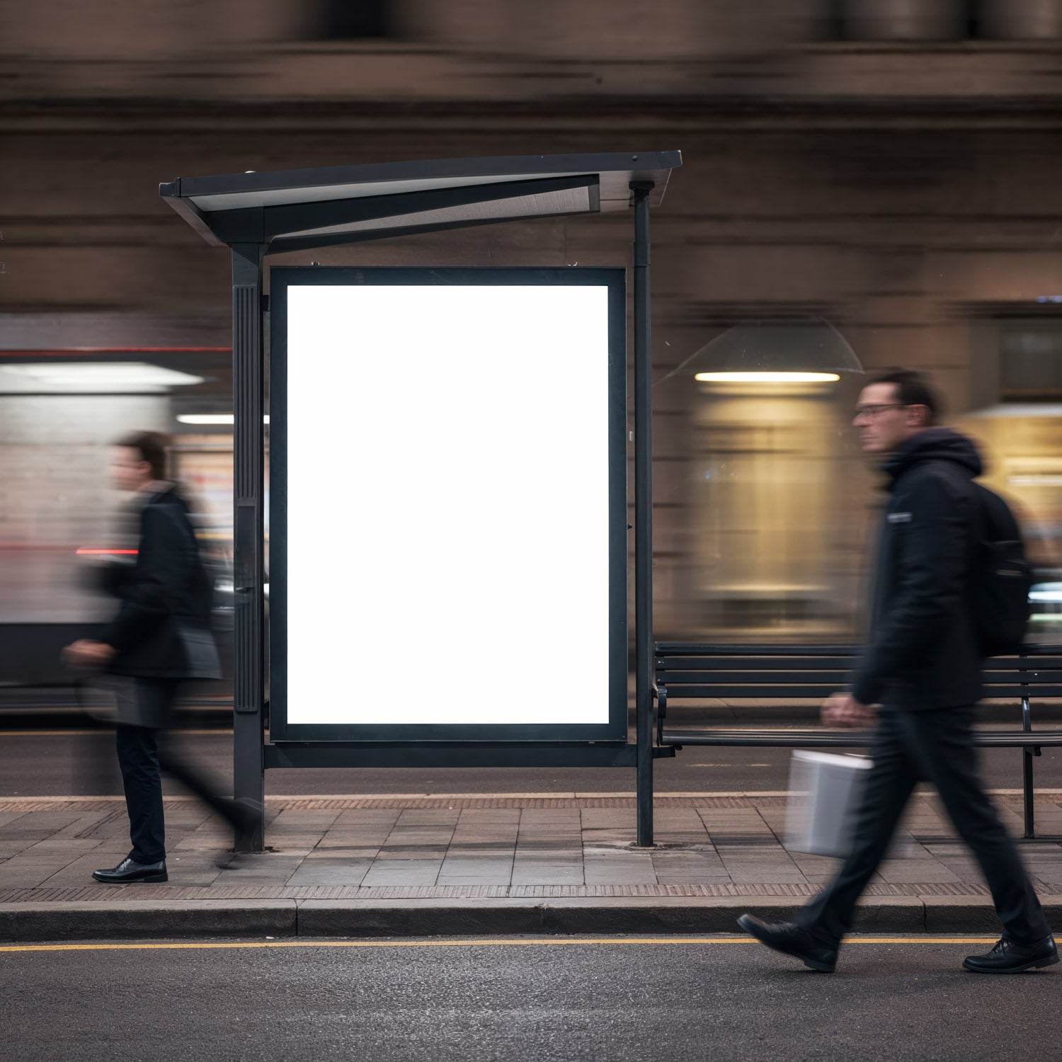 Blank illuminated bus stop ad with commuters passing by