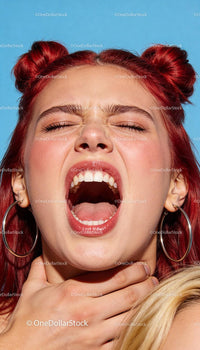 Young woman expressing intense emotion with red hair