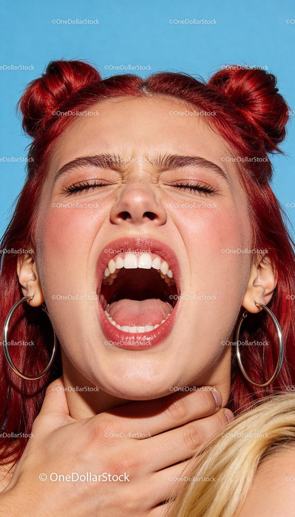 Young woman expressing intense emotion with red hair