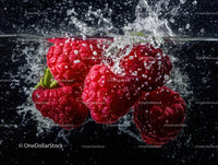 Vibrant Ripe Raspberries Splashing in Water