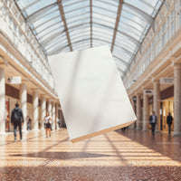 Blank white flyer floating in bright shopping mall corridor