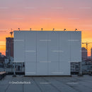 Empty Rooftop with Urban Skyline and Sunset Sky