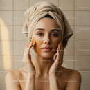 Young Woman Applying Facial Mask for Skin Care and Relaxation