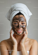 Young Woman with Facial Mask and Turban Smiling During Skincare Routine