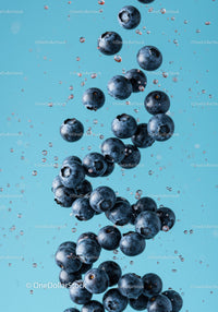 Fresh blueberries suspended in sparkling water splash