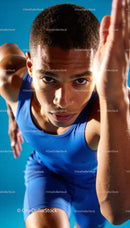 Focused young male sprinter taking off from the start line