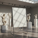 Blank easel in modern art gallery with classical sculptures