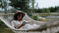 Woman Relaxing in Hammock Reading Book Outdoor Nature Scene