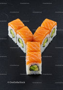 Fresh salmon sushi rolls with cucumber on black slate