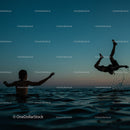 Playful Moments in the Water at Sunset