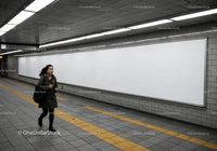 Woman Walking in Subway Tunnel with Yellow Tactile Tiles