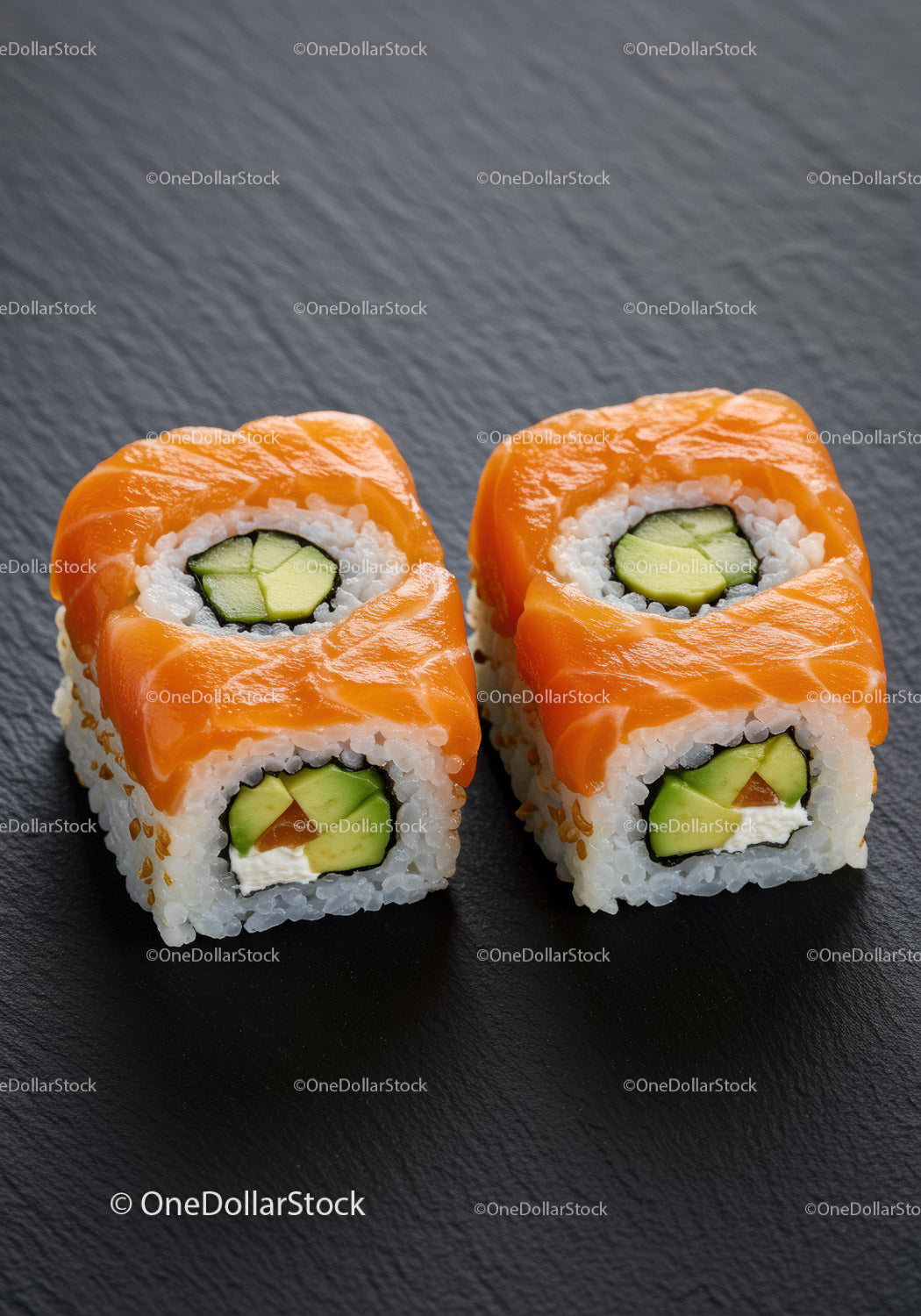 Fresh Salmon Avocado Sushi Rolls Served on Black Slate