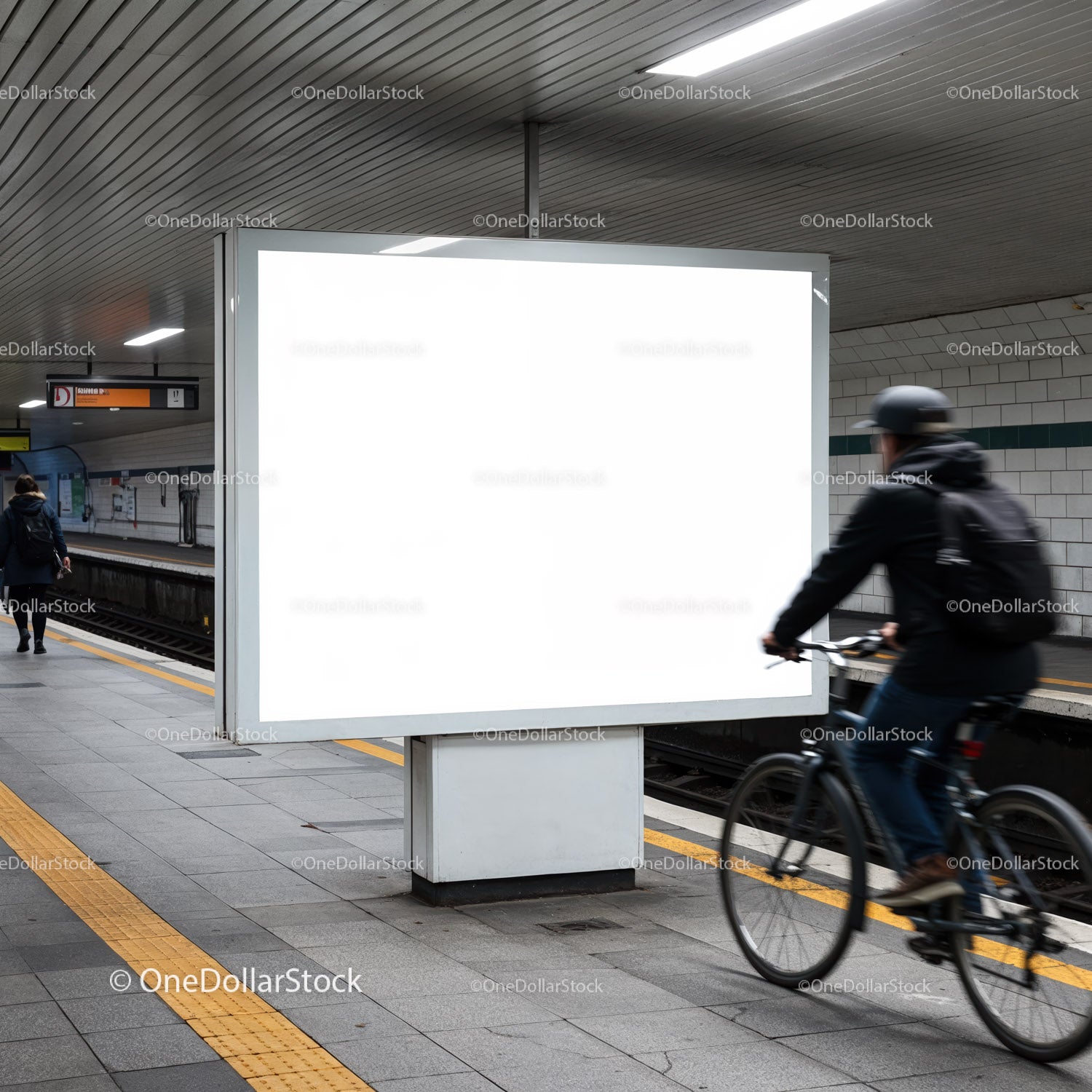 Urban subway platform with blank billboard and cyclist