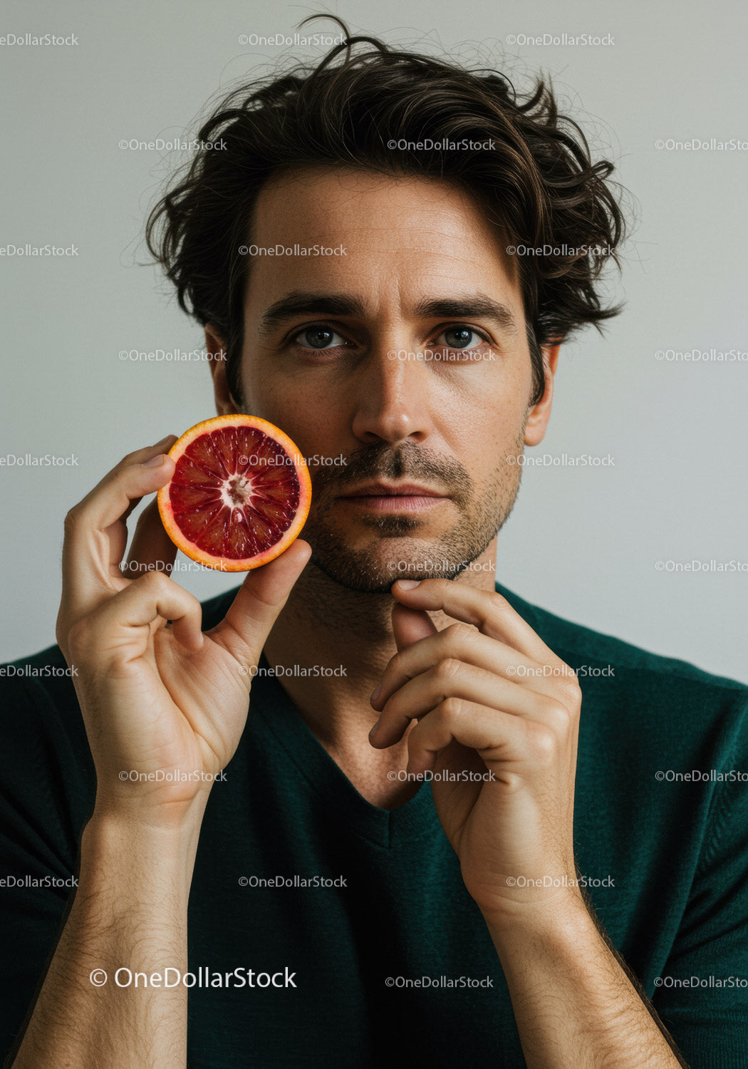 Man Holding Red Blood Orange in Close-Up Portrait
