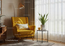 Cozy corner with yellow armchair and indoor plant