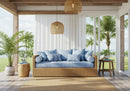 Cozy wicker sofa with blue cushions in tropical veranda