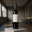 Dark wine bottle with blank label on concrete pedestal