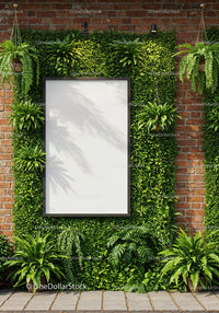 Blank board surrounded by lush green plants on brick wall