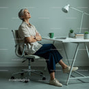 Thoughtful Woman Enjoying Peaceful Moment in Modern Office