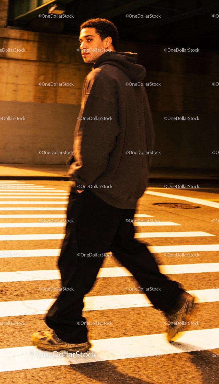 Young man walking confidently in urban streetwear