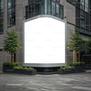 Blank urban billboard framed by modern planters and trees