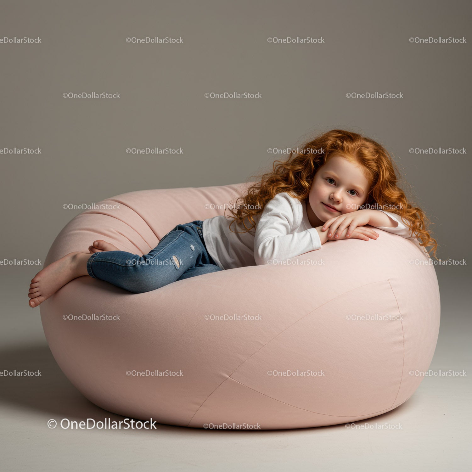 Relaxed redhead girl lying on soft pink bean bag