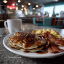 Stack of Fluffy Pancakes with Melted Butter and Syrup