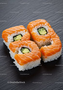 Fresh Salmon Sushi Rolls with Avocado on Black Slate