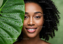Smiling Woman with Curly Hair and Green Leaf in Fresh Natural Setting