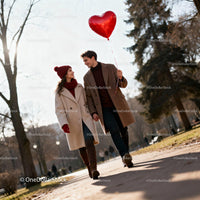 Couple Walking Outside Holding Heart-Shaped Balloon