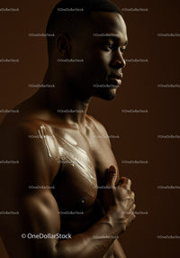 Muscular Male Model with Body Paint and Artistic Makeup in Studio