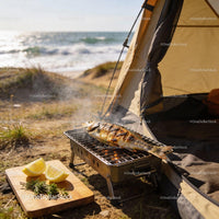 Grilled Fish Cooking on Portable BBQ by Beach Tent