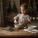 Young Girl Pouring Water in Bowl in Rustic Kitchen