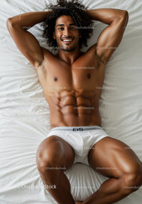 Smiling Fit Man Relaxing on White Bed in Underwear