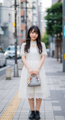 Young Woman in White Lace Dress Standing on City Street