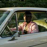 Young Man in Pink Shirt Sitting in Vintage Car on a Sunny Day