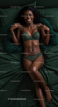 Smiling woman relaxing on dark green bedding in lingerie