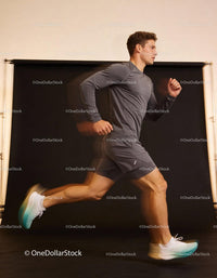 Athletic young man running fast indoors with motion blur