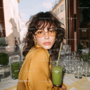 Stylish Young Woman Wearing Yellow Sunglasses in Urban Street Scene