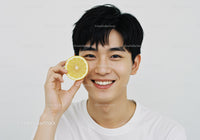Young Man Smiling Holding Lemon Slice Brighten Day Cheerful Portrait