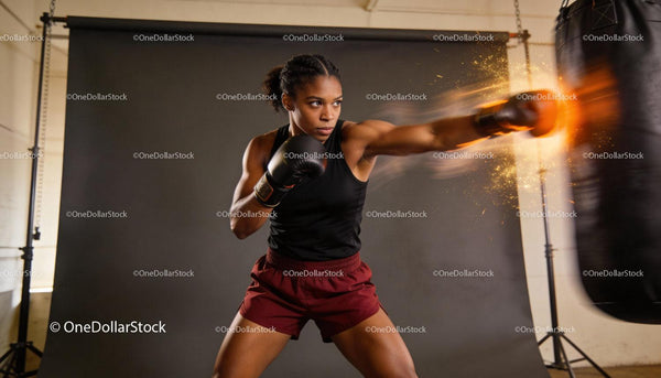 Focused female boxer delivering powerful punch during training