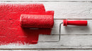 Red Paint on Wooden Surface with Roller in Background