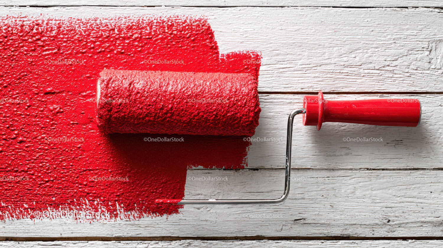 Red Paint on Wooden Surface with Roller in Background