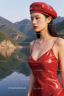 Elegant Young Woman in Red Leather Dress by Mountain Lake Scene