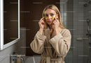 Woman Applying Gold Eye Patches for Skincare Routine